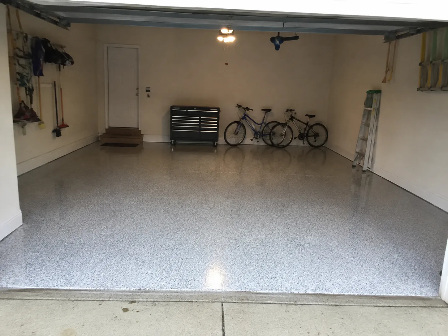 Finished three-car garage floor coating, phone photo from the job